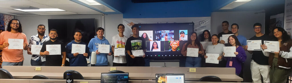photo of students in a room and some on a screen holding up their certificates