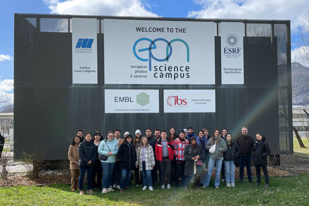 group of people standing in front of the EPN Science Campus sign